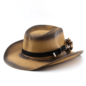 Detail of vintage straw cowboy hat featuring bronze steampunk goggles with metal spikes