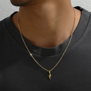 Golden stainless steel lightning bolt pendant necklace on a model with O-chain