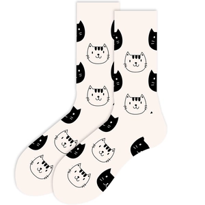 Detailed close-up of beige crew socks featuring cute cartoon cat face patterns in high-quality cotton