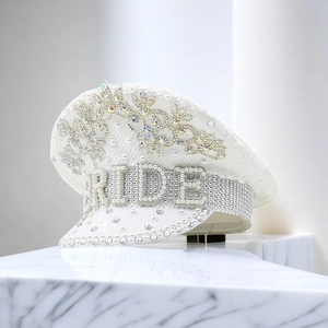 Close-up of pearl 'BRIDE' lettering and rhinestones on white sequin captain hat