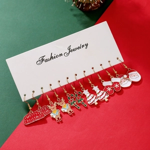 Close-up of 6 pairs of festive Christmas earrings including Santa Claus and reindeer designs
