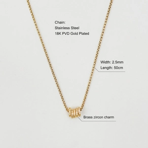Detailed macro view of 18K gold plated stainless steel pearl chain with zircon ring pendant