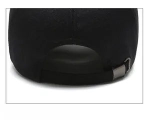 Gros plan sur la boucle en métal et la texture du tissu en sergé de la casquette noire
