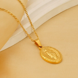 Macro view of gold-plated Virgin Mary oval pendant on a stainless steel O-chain necklace