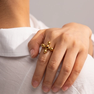 Detail of a vintage 18K gold plated stainless steel cross ring with a tiger eye stone