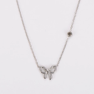 Close-up of silver bow pendant with crystal drop and O-chain in stainless steel