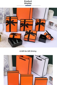 Detailed view of orange jewelry gift boxes with black edges and matching ribbon handles