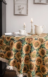 Close-up of thick sunflower jacquard round tablecloth with beige fringe tassels detail