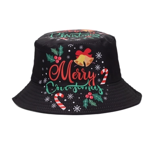 Close-up view of black Christmas bucket hat featuring festive Merry Christmas print and bells
