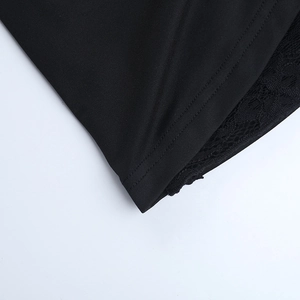 Détail de la couture à double aiguille et bordure en dentelle noire sur mini robe