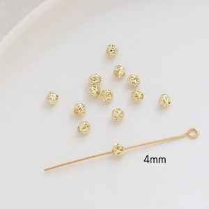 Macro detail of 4mm gold plated hollow metal spacer beads for DIY jewelry making