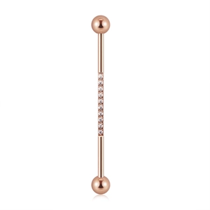 Macro view of rose gold industrial barbell with sparkling pavé-set clear zircon stones