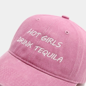 Detail of 3D embroidery on washed pink cotton baseball cap with vintage finish