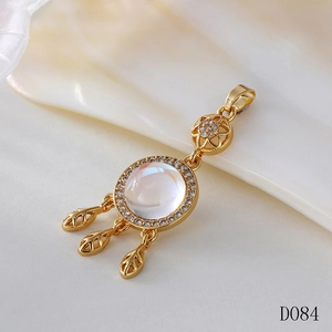 Macro shot of a golden dreamcatcher pendant with moonstone and leaf details