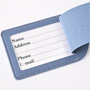 Blue PU leather luggage tag detail with transparent ID card slot and elastic strap