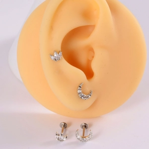 Surgical steel labret set with moon and flower shapes on a silicone ear model display