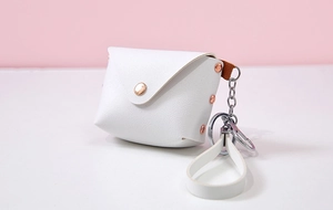 Detailed macro view of white PU leather mini wallet with rose gold stud and wrist strap