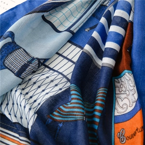Detailed close-up of blue and orange linen-feel scarf with intricate pattern and texture