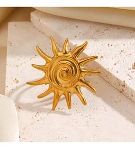 Detailed view of a vintage gold sun ring with spiral texture on a stone background