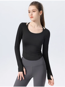 Close-up of slim-fit yoga top featuring thumbholes and curved hem in black fabric