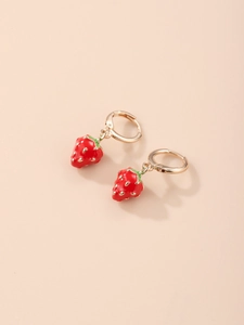 Detail of red strawberry drop earrings with gold hoops and enamel texture finish