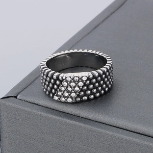 Detailed view of vintage silver ring with five rows of crystals and beaded textures
