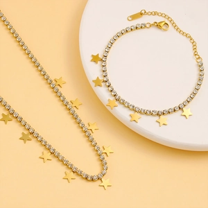 Detail of gold-plated chain set with white cubic zirconia and star-shaped pendants