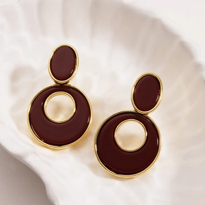 Detail view of 18K gold-plated hollow circle earrings with burgundy resin filling