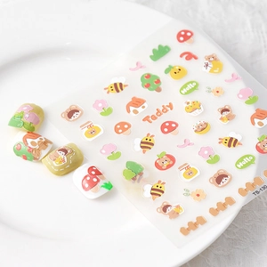 Macro view of 5D cute teddy bear and mushroom embossed nail art stickers on a white plate