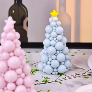 Bubble Christmas tree scented candles in blue and pink with yellow star toppers
