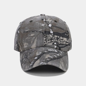 Close-up of the camouflage baseball cap showing twill fabric texture and stitched eyelets