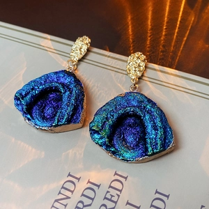Detail of blue purple crystal druzy earrings with gold textured irregular metal settings