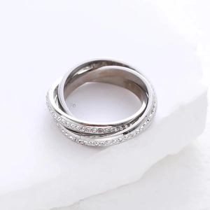Elegant silver interlocking three-band ring with white micro-pave crystals on white stone