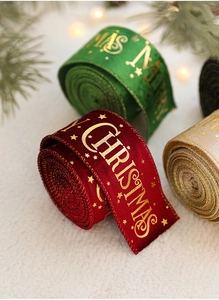 Detail of velvet Christmas ribbons with gold foil Merry Christmas and stars print