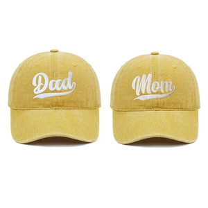 Close-up of yellow washed cotton baseball caps with Dad and Mom white embroidery