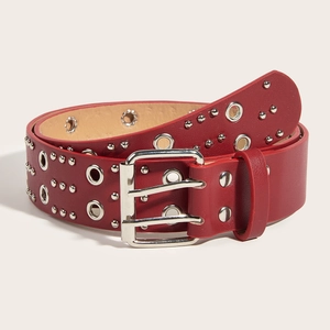 Detail of red punk leather belt with silver double grommets and metal eyelet decoration