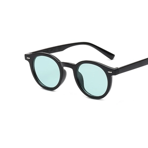 Retro small round frame sunglasses with light green lenses and black frame in 45-degree view