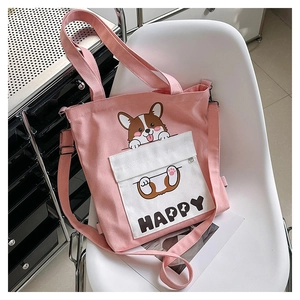 Detail of pink canvas tote featuring cute corgi print and Happy text on white pocket