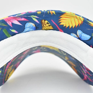 Close-up of wide-brim sun hat interior with floral butterfly print and stitched sweatband