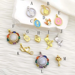 Macro view of assorted hip hop jewelry charms including Mary, heart lock and colorful gems