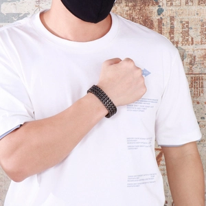 Close-up of triple-layered black dragon bone chain bracelet with magnetic buckle clasp