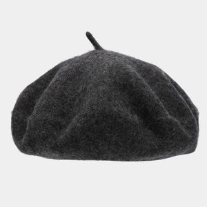 Detailed texture of thick dark grey wool beret showing classic top stem and felt fabric