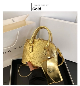Close-up of golden crocodile pattern shell bag with matching small coin purse detail