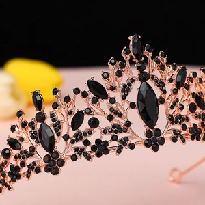 Macro detail of rose gold tiara featuring marquise cut black gemstones and floral patterns