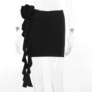 Detail of high waist black mini skirt featuring a 3D fabric rose and ruffled side trim