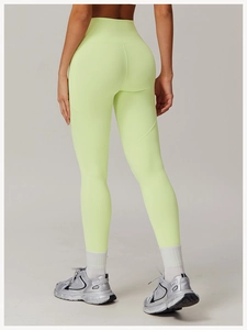 Rear view of high-waist fluorescent yellow yoga pants showing booty lifting seams and fit