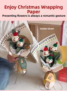 Close-up of Christmas gift wrapping paper with gingerbread man and festive decorations