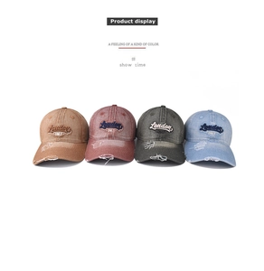Detail display of four washed denim baseball caps with London ONLY embroidery and distressed edges