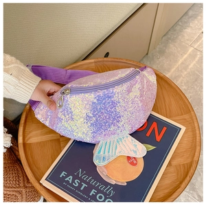 Detail of purple sequin mermaid waist bag with adjustable strap on a wooden tray
