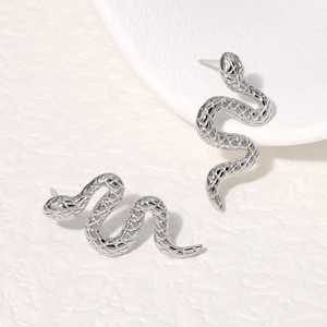 Minimalist silver snake stud earrings in high polished stainless steel for a punk look